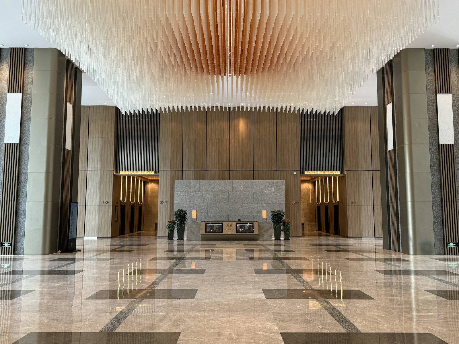 A polished marble lobby with a reception desk in a corporate financial building